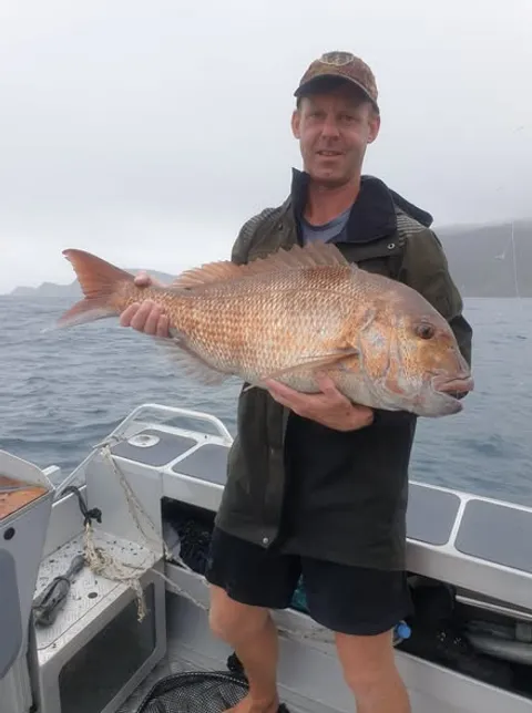 2021 '2 Grander' - member holding a solid snapper aboard a trailer boat